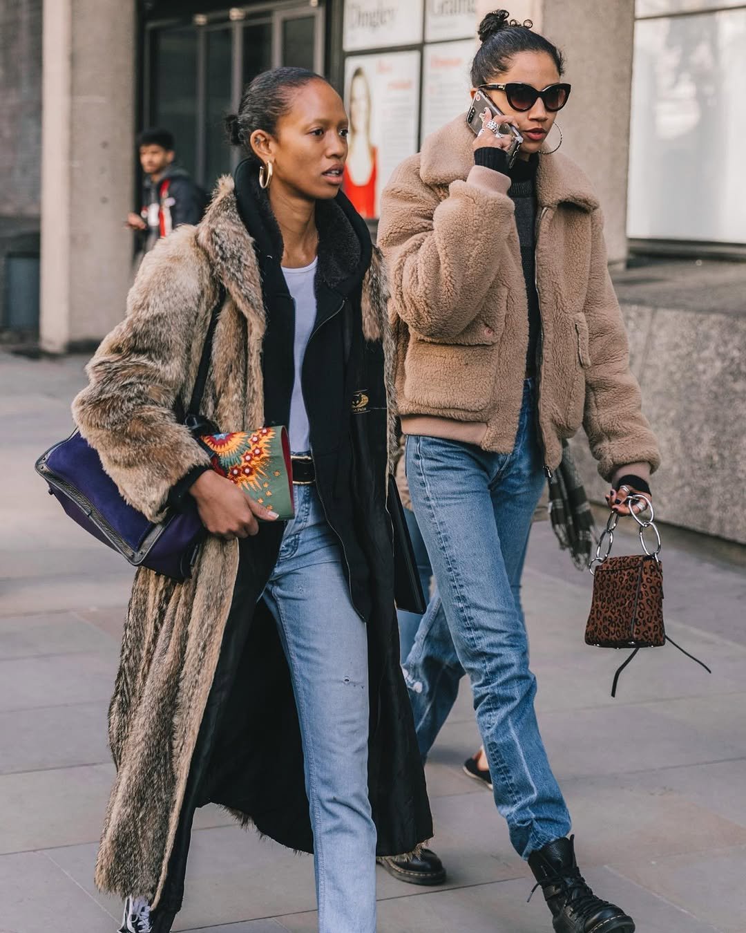Two street-style looks pair plush outerwear with light blue denim and statement handbags.