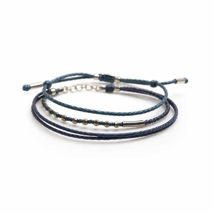 dark blue stacked cord and metal bracelets